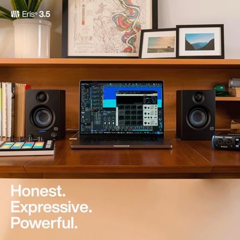 Two PreSonus Eris monitors positioned on a desk on either side of a computer screen in a home workspace.