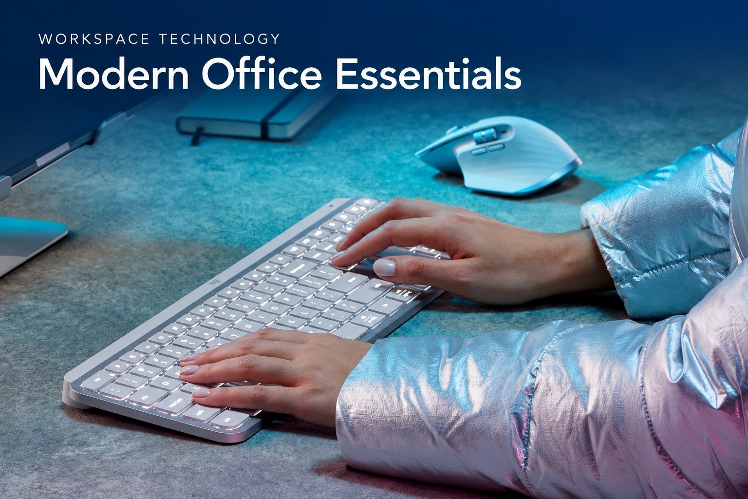 Hands typing on a Logitech keyboard beside a wireless mouse. The banner reads Workspace Technology: Modern Office Essentials.